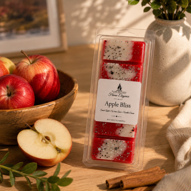 Packaged wax melts labeled 'Apple Bliss' on a table with apples and cinnamon sticks soy wax melts by Flame Elegance. 