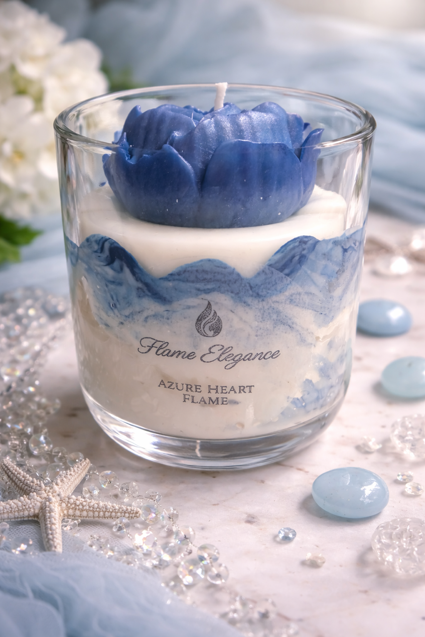 Candle with blue floral design and 'Flame Elegance' branding on a decorative surface.