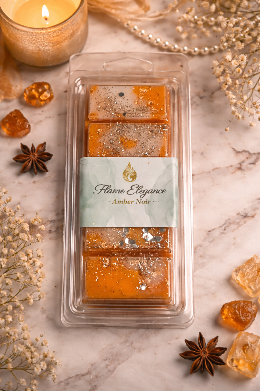 Packaged amber wax melts with 'Flame Elegance' label on a marble surface with decorative elements.