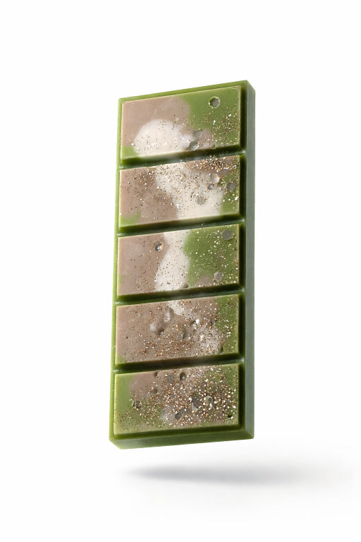 Close up of Apothecary wax melt bar with mica powder and gold glitter. White background. 