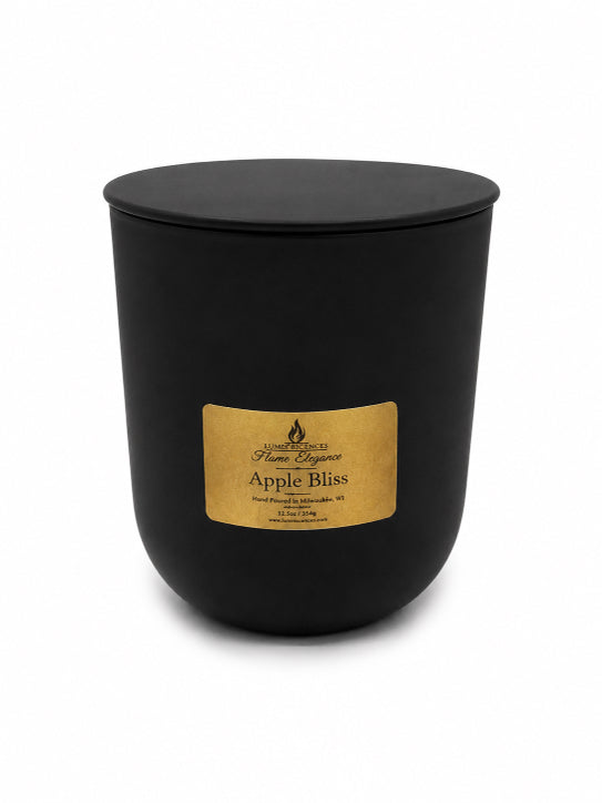 Black candle with a gold label on a white background with a slim metal black lid by Flame Elegance