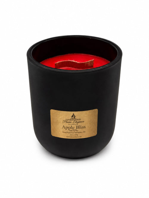 Black candle with a red interior and 'Apple Bliss' label on a white background by Flame Elegance