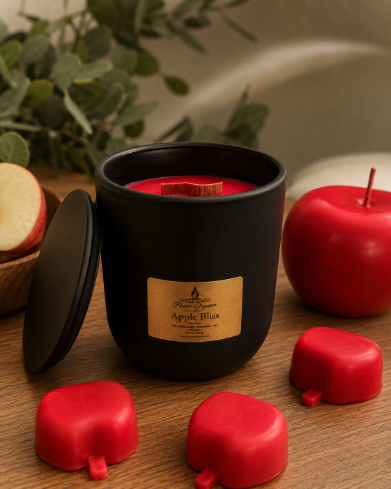 Black candle vessel  with 'Apple Bliss' label on a wooden surface with red apple-shaped candles and leaves in the background by Flame Elegance. 
