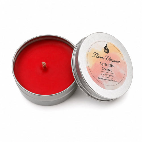 An open round silver tin candle with bright red wax and a wick, shown next to its lid. The lid has a circular label reading 'Flame Elegance Apple Bliss Scented' on a white background.