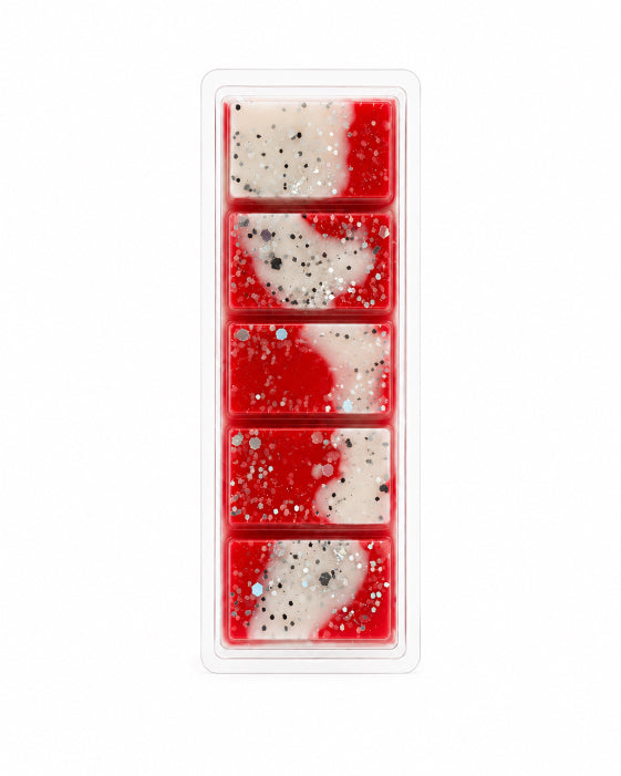 Rectangular tray with five red and white wax melts featuring artistic designs on a white background.