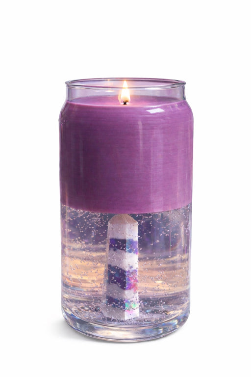 Purple candle with apothecary fragrance bottom is gel wax with aura crystal wand embedded. white background. 