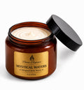 Brown jar of 'Mystical Waters' whipped body butter by Flame Elegance with a black lid on a white background