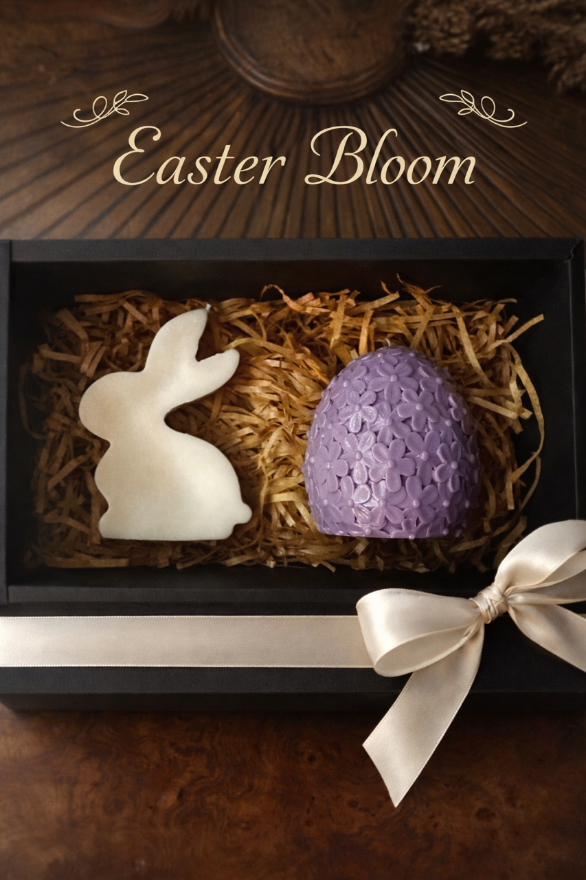 Easter-themed decorative items including a rabbit and egg in a box with straw, on a wooden surface.