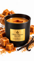 butter rum soy candle by flame elegance with butterscotch candy next to it and all white background