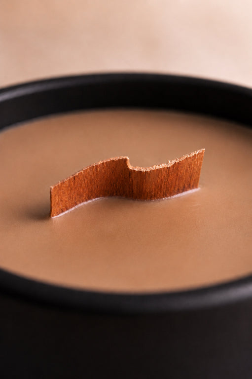 Wood Wick Gingerbread Soy Candle up close showing wick by Flame Elegance housed in a black glass sonoma vessel. 