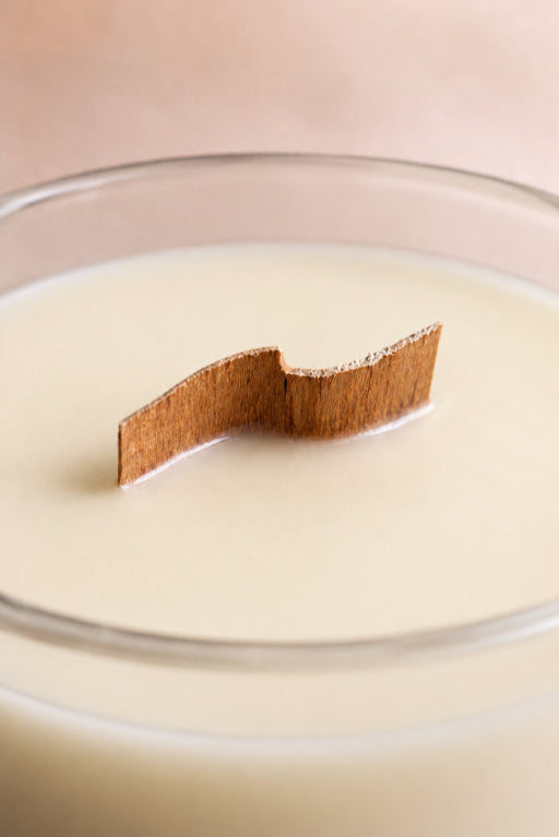Candle in a glass jar with a curved wood wick up close image by Flame Elegance. 