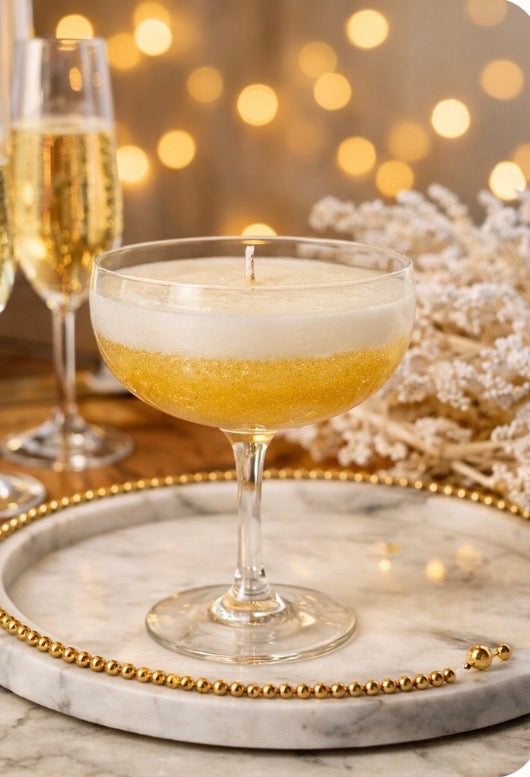 Champagne toast luxury candle in elegant coupe glass with sparkling citrus and bubble notes, festive artisan home fragrance.