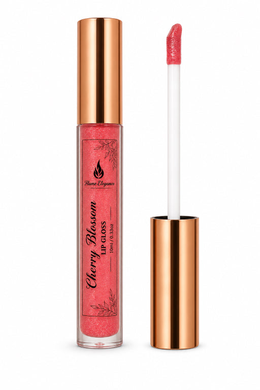 A tube of coral pink liquid lip gloss with a metallic rose gold cap, shown next to its applicator wand on a clean white background. The brand name Flame Elegance is visible on the label.