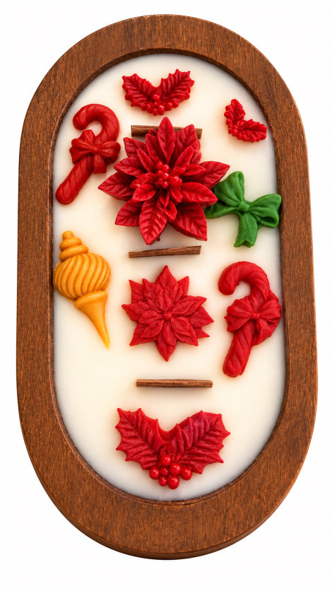 An oval wood dough bowl 3 wood wick soy candle  featuring red and green Christmas-themed relief designs, including poinsettias, candy canes, holly leaves, and a small yellow ornament, set against a white background.