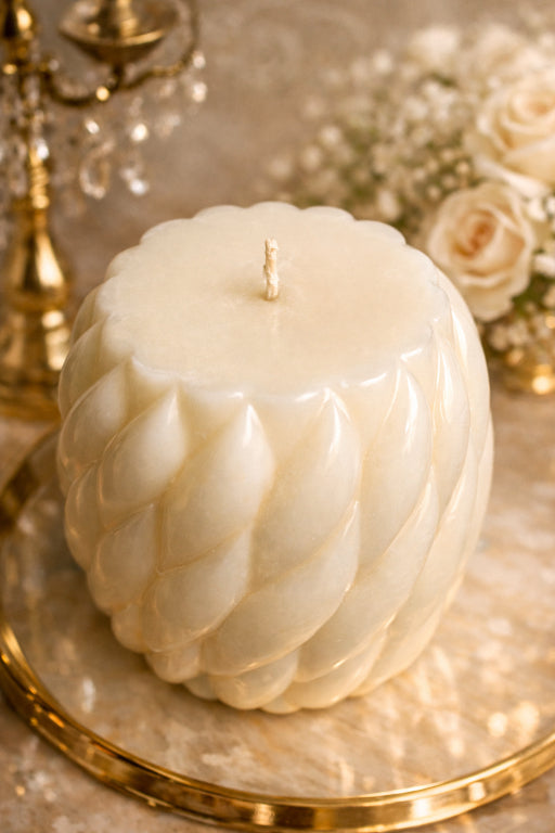 Close up of sculpted spiral ivory pillar candle texture with soft ambient lighting