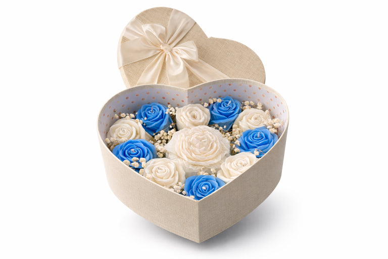 Garden of Grace Elegant Heart Box Gift Set Scented with Mystical Waters. White background. Candles consist of blue and white roses with large peony in the center placed in ivory heart shaped keepsake boxy. 