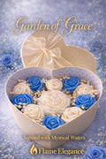 Garden of Grace Gift Set in Ivory Heart Shaped box. Blue and white candle roses with large ivory peony in the center adorned with baby's breath by Flame elegance