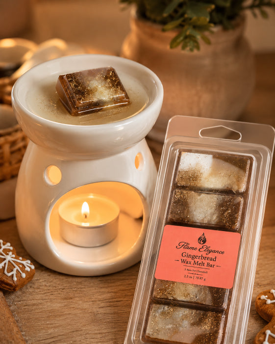 A packaged gingerbread-scented wax melt bar from Flame Elegance is shown next to a white ceramic candle warmer with a lit tea light candle. The wax melts inside the warmer and one is shown melting in the center of the vessel, creating a cozy, warm atmosphere on a wooden surface.