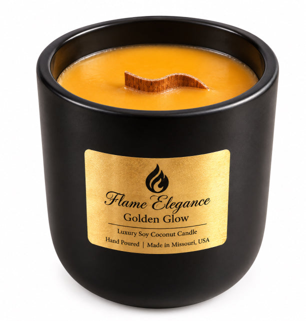 A black soy  candle in a matte black jar with a gold label reading 'Flame Elegance Golden Glow' and a wavy wooden wick, shown on a white background.