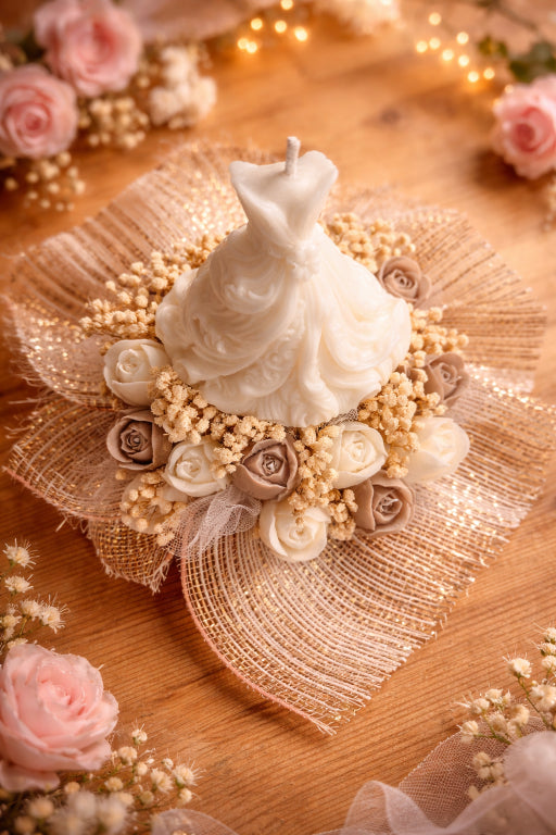 Decorative wedding dress candle topper top view and taupe and ivory tulips below the wedding dress by Flame Elegance and scented with love spell. 