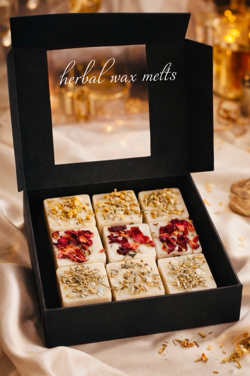 Strong scented eco-friendly herbal wax melts by Flame Elegance for wax warmers featuring rose, lavender, and chamomile botanicals. Open box with elegant background. 