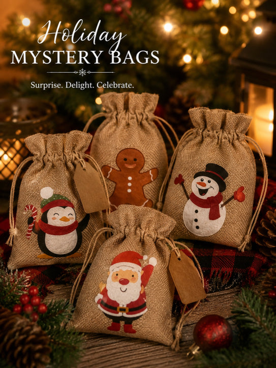 Five small burlap drawstring gift bags decorated with festive holiday illustrations, including a penguin, gingerbread man, snowman, and Santa Claus, arranged on a rustic table with Christmas decorations and warm holiday lights in the background. Text at the top reads 'Holiday Mystery Bags' with the tagline 'Surprise.