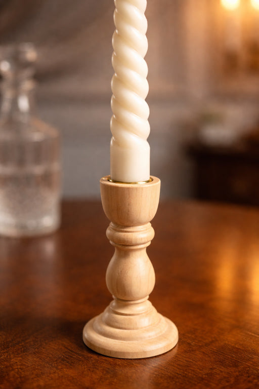 Flame Elegance close up of base of spiral taper candle. Set minimalist ivory dinner or wedding celebrations candles. 