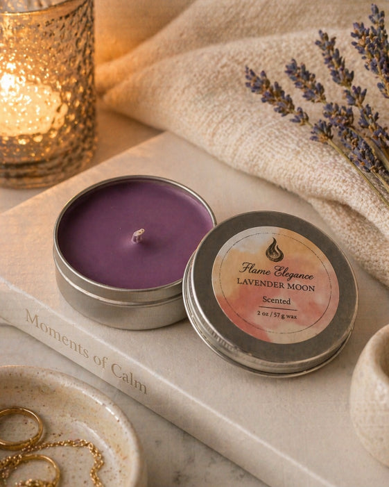 Scented candle in a tin with lavender moon label on a marble surface with a candle and towel in the background.