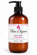 An amber plastic pump bottle of Flame Elegance Love Spell Body Wash on a clean white background.