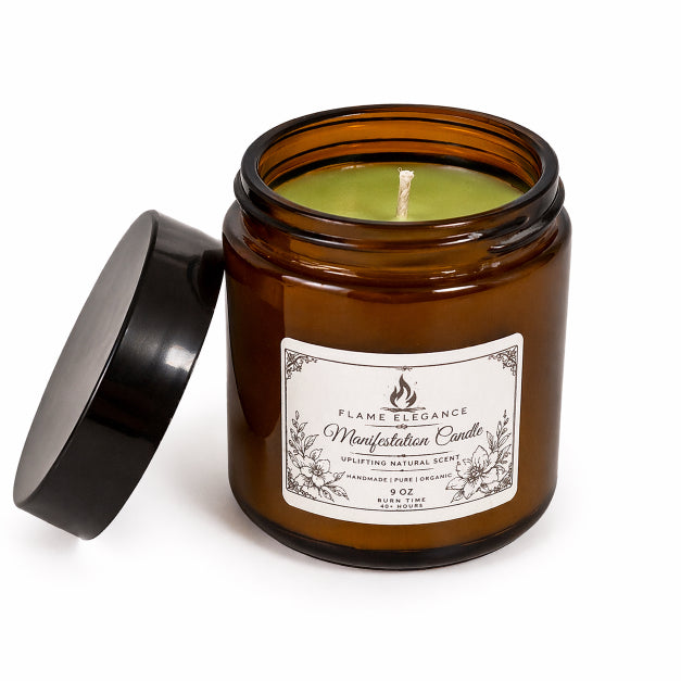 amber glass jar titled manifestation candle bergamot aura scent white flame elegance with white background and black lid propped up on side of candle. 