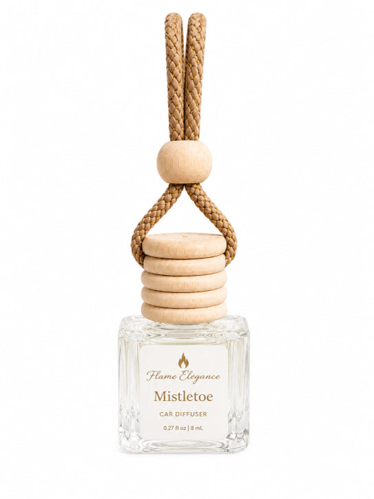 A clear glass car diffuser bottle with a natural wood stopper and a braided tan rope hanger, labeled 'Flame Elegance Mistletoe Car Diffuser' on a white background.