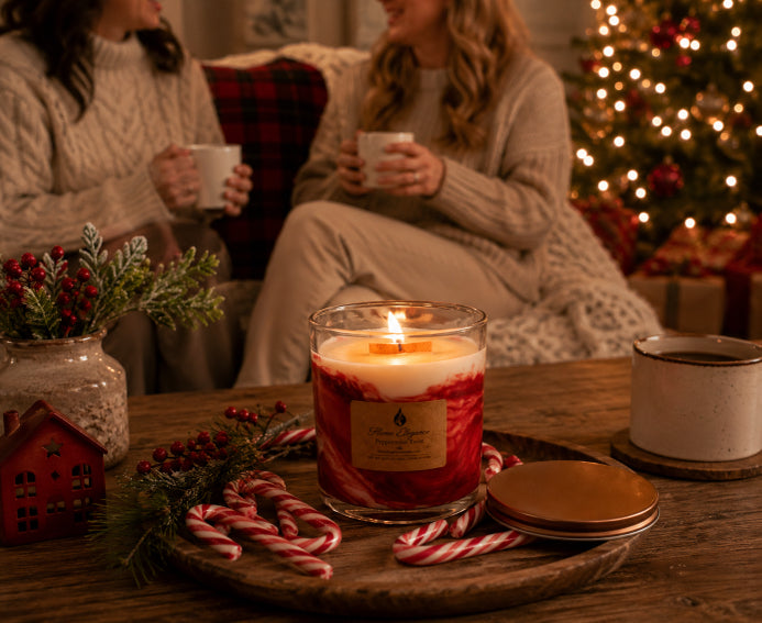 Peppermint Twist Wood Wick Candle Lit on coffee table with candy canes surrounding it and two women sitting on couch drinking coffee and talking. Candle by Flame Elegance. 
