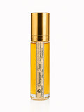 Gold and clear bottle of 'Champagne Toast scent luxury perfume oil on a white background by Flame Elegance