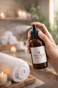 Hand spraying Jasmine sea flower room spray in spa-style heirloom bathroom setting