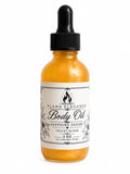 Bottle of Flame Elegance shimmering velvet elixir sapphire desire body oil with a dropper on a white background by Flame Elegance