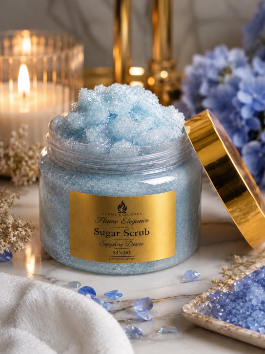 sapphire desire luxury sugar scrub by Flame Elegance blue sugar scrub with lid open and candle in background with blue flowers and blue sapphires