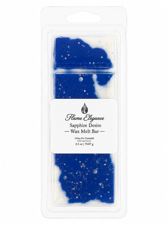 A packaged wax melt bar in a clear plastic clamshell package with a white label reading 'Flame Elegance Sapphire Desire Wax Melt Bar.' The wax inside is blue and white with small white speckles.