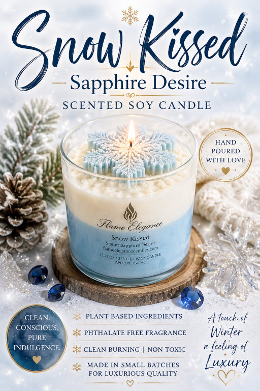 A scented soy candle labeled 'Snow Kissed - Sapphire Desire' by Flame Elegance, shown lit in a clear glass jar with a blue and white snowflake design on the wax. The candle is styled with pinecones, blue beads, and white faux snow, with promotional text overlays around it on a snowy winter background.