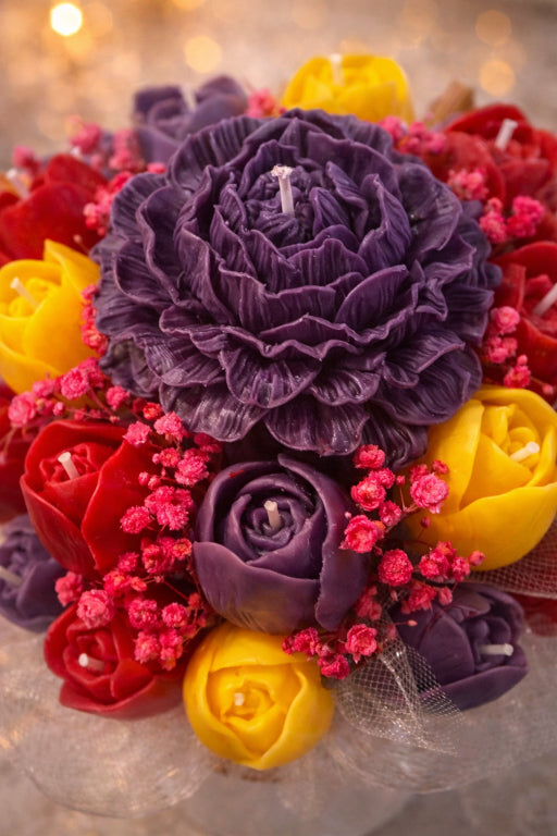 Close up detail of purple wax peony and wax tulip candles and floral arrangement in Spring Empress Bouquet candle centerpiece.