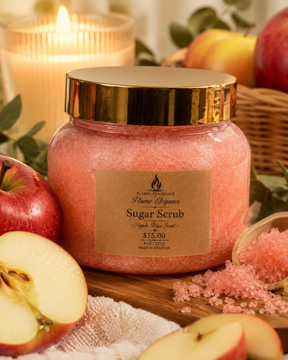 Jar of sugar scrub with apples and a candle on a wooden surface scented Apple Bliss fragrance by Flame Elegance